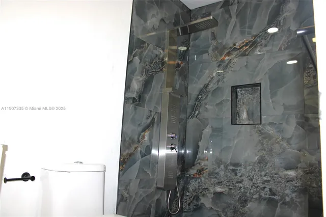 a picture of a bathroom with a shower