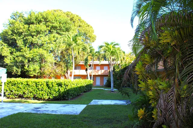 a view of a house with a tree and plants