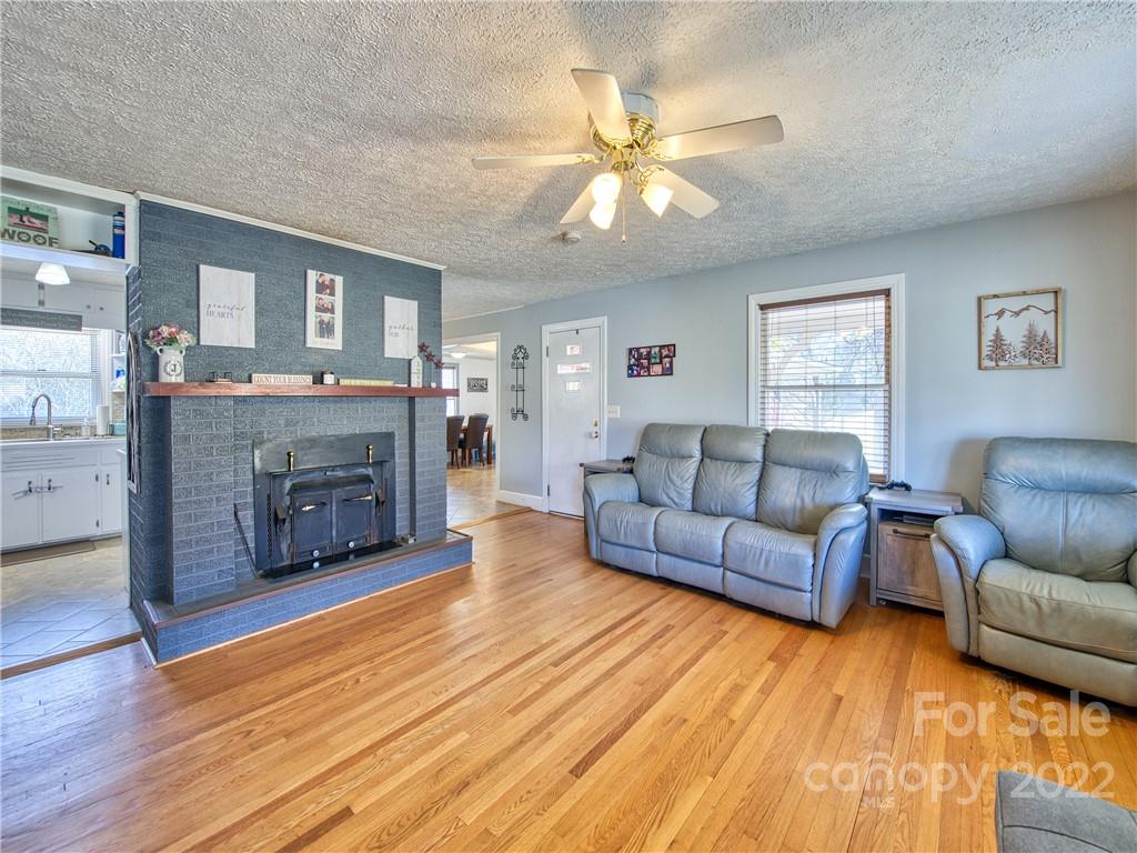 970 Ratcliff Cove Road Waynesville, NC 28786 - Photo 11 of 24 a living room with furniture and a fireplace