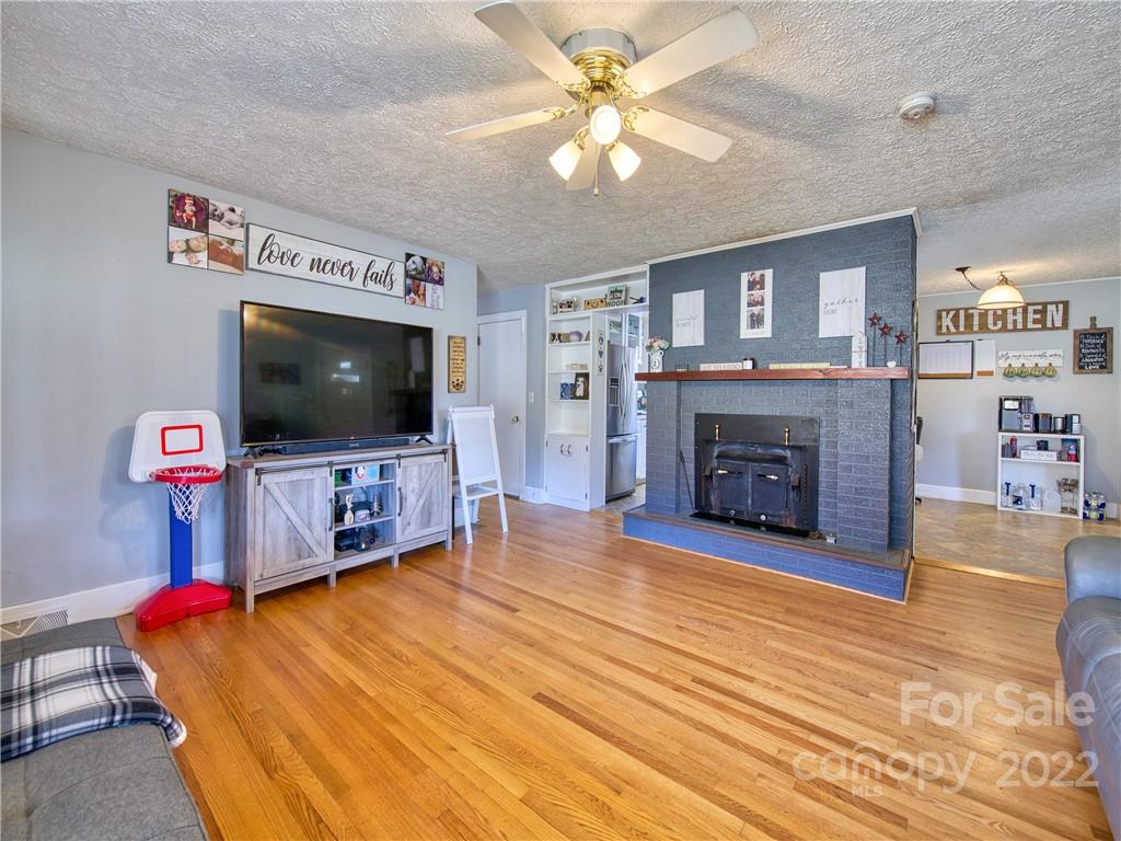 970 Ratcliff Cove Road Waynesville, NC 28786 - Photo 12 of 24 a living room with furniture and a flat screen tv