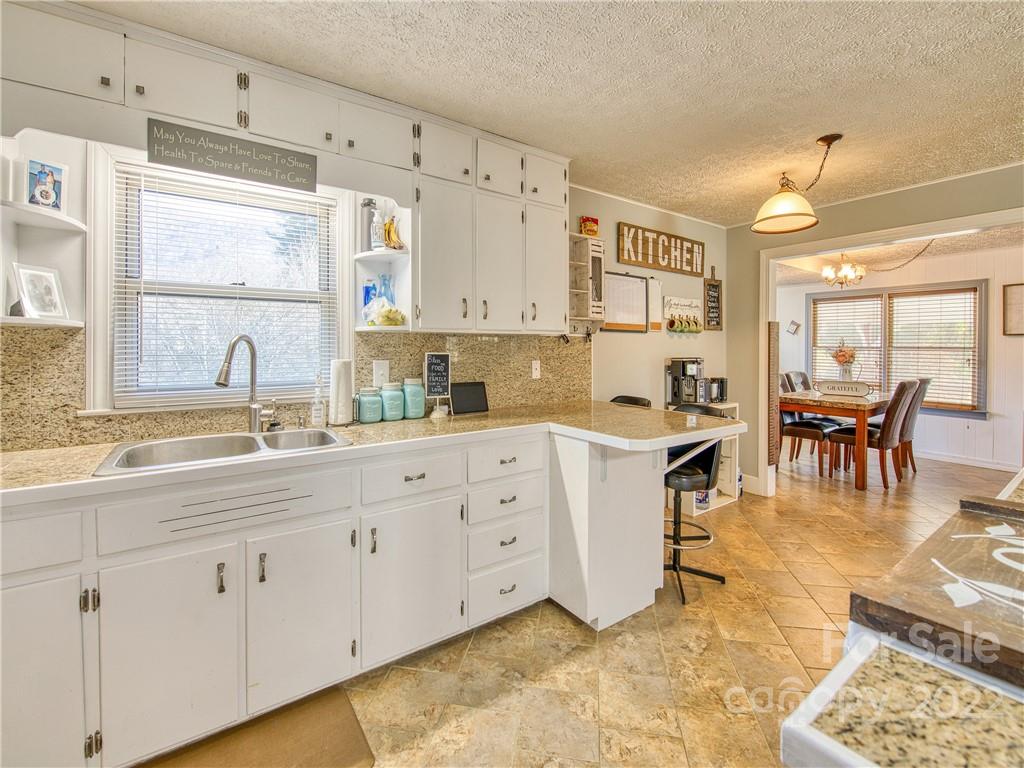 970 Ratcliff Cove Road Waynesville, NC 28786 - Photo 15 of 24 a kitchen with sink cabinets and outdoor view