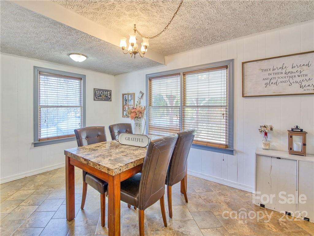 970 Ratcliff Cove Road Waynesville, NC 28786 - Photo 16 of 24 a view of a dining room with furniture
