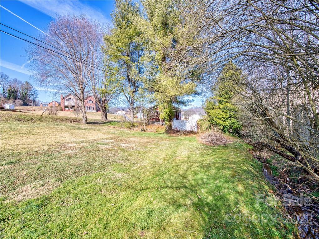 970 Ratcliff Cove Road Waynesville, NC 28786 - Photo 6 of 24 a view of yard with swimming pool and green space