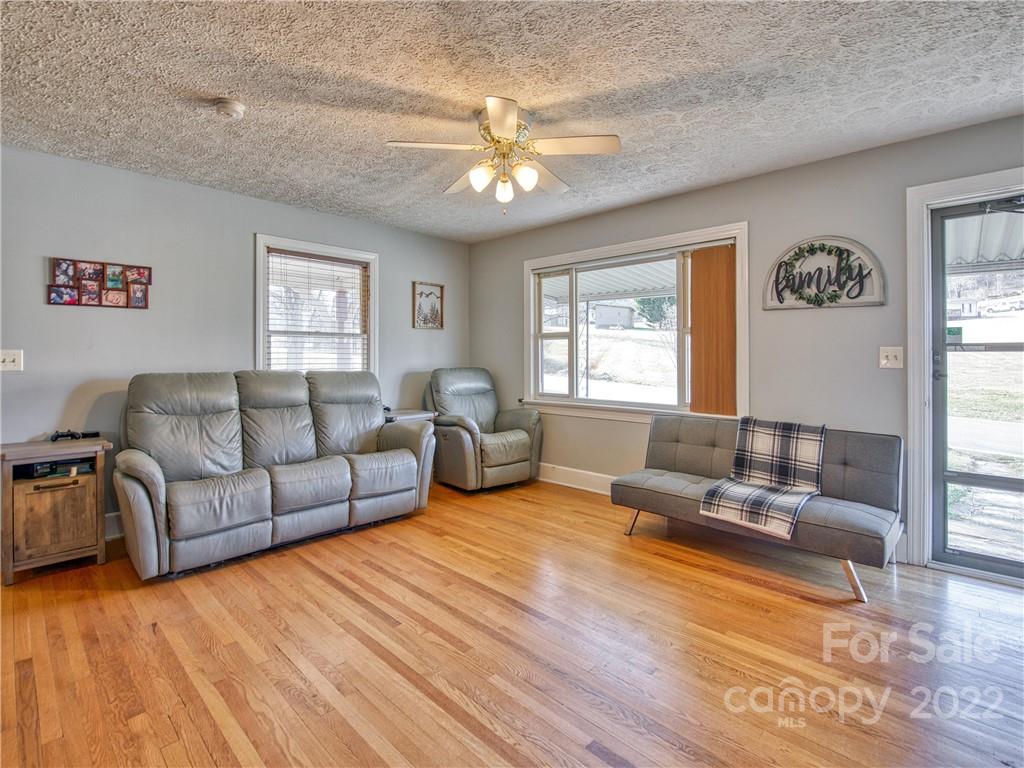 970 Ratcliff Cove Road Waynesville, NC 28786 - Photo 9 of 24 a living room with furniture and a large window