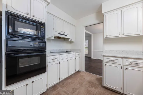 a kitchen with cabinets stainless steel appliances and sink