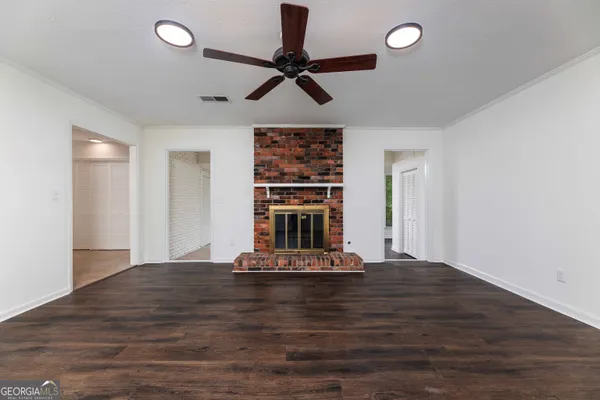 a view of a room with a ceiling fan window and a ceiling fan