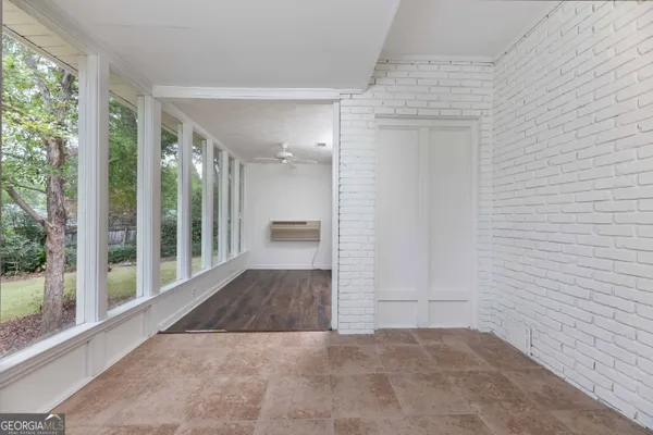 a view of a hallway with wooden floor and entryway