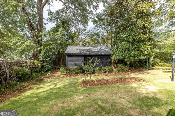 a backyard of a house with table and chairs