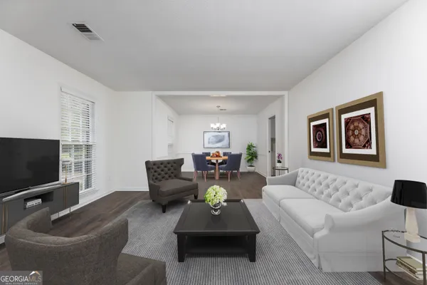 a living room with furniture and a flat screen tv