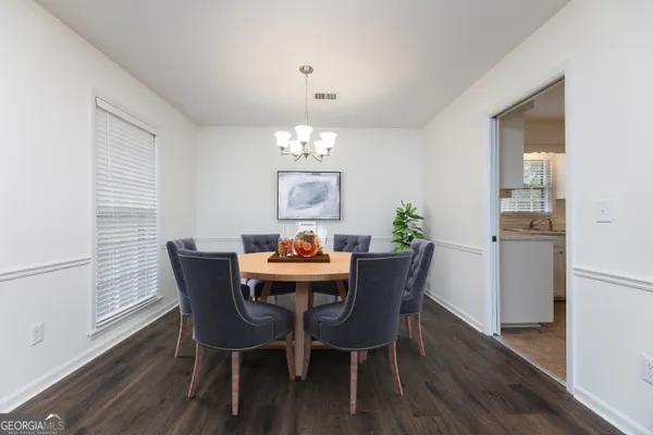 a view of a dining room with furniture and wooden floor