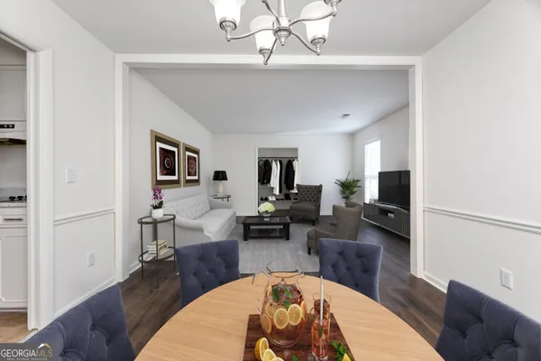 a living room with furniture or wooden floor and a flat screen tv