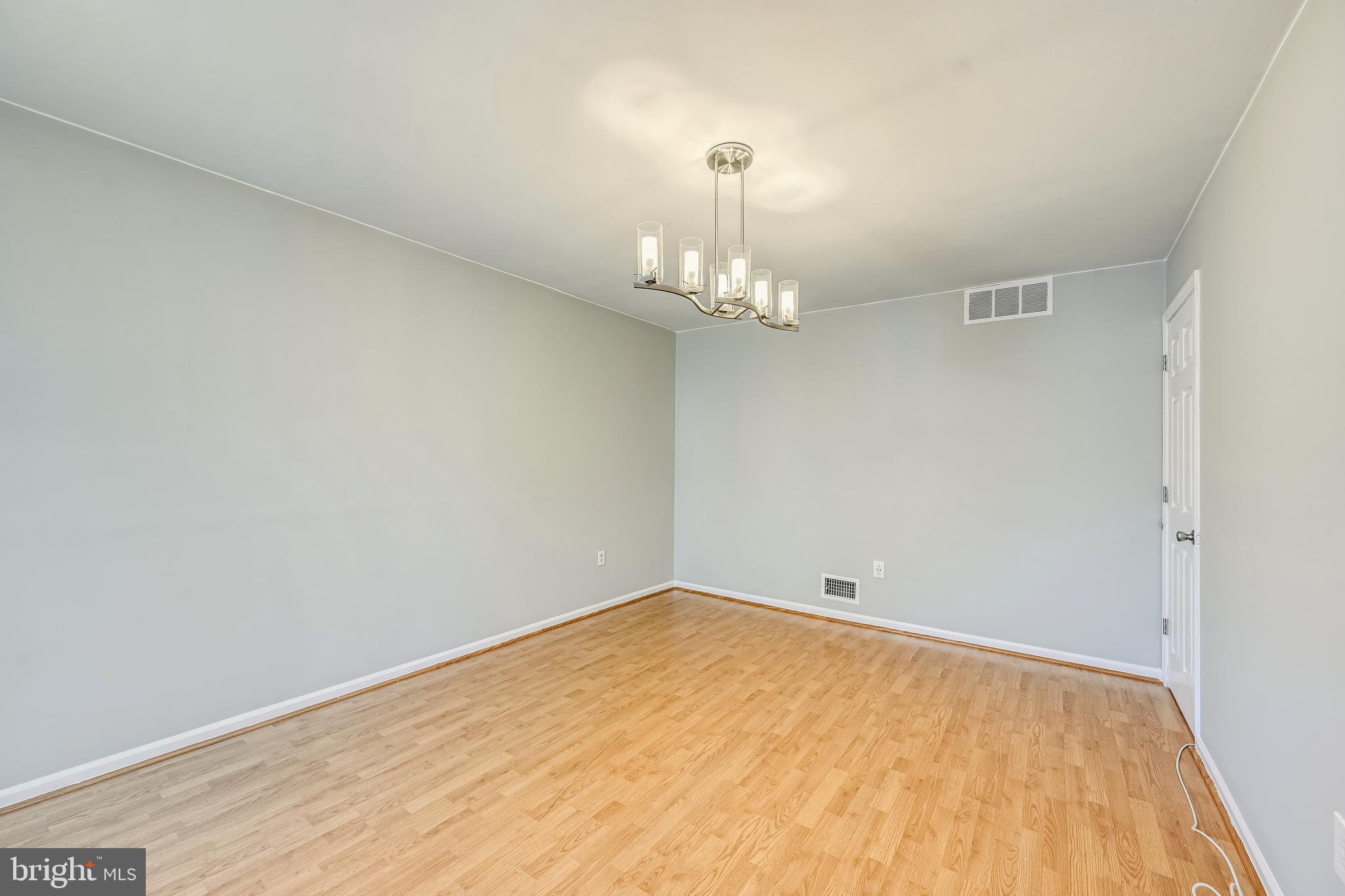 2116 Kings House Road Silver Spring, MD 20905 - Photo 17 of 37 a view of a room with wooden floor and chandelier