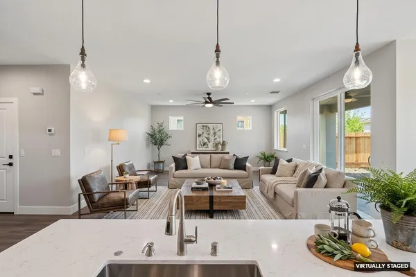 a living room with furniture and a chandelier