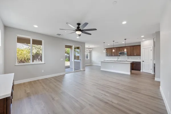a bathroom with a toilet sink double vanity and mirror