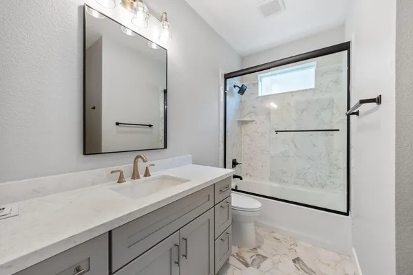 a picture of a bathroom with a shower