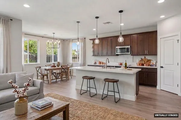 a large kitchen with stainless steel appliances kitchen island granite countertop a large island in the center