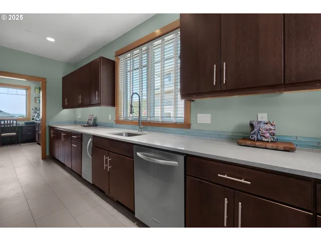 a kitchen with granite countertop cabinets and window