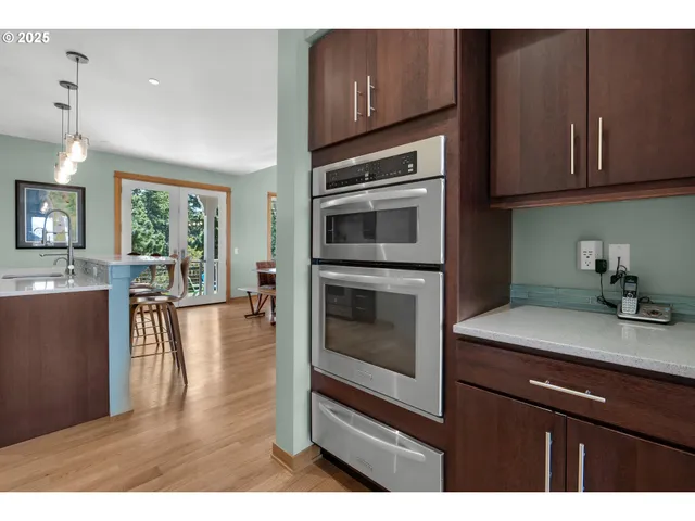 a kitchen with stainless steel appliances granite countertop wooden cabinets a stove a sink and dishwasher