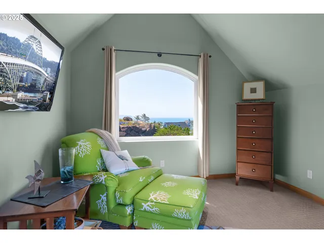 a living room with furniture and a floor to ceiling window