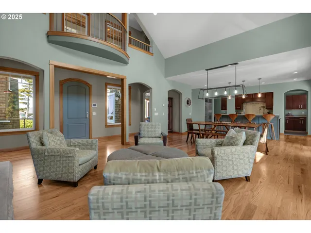 a living room with furniture and a chandelier