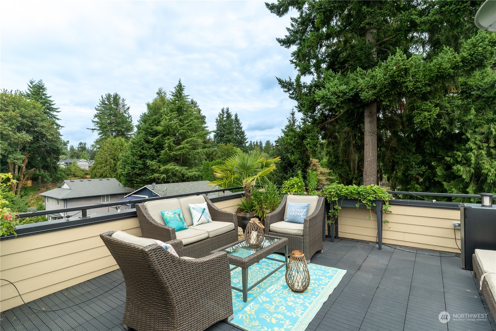 18613 103rd Avenue Northeast Bothell, WA 98011 - Photo 29 of 35 a view of a patio with couches table and chairs and potted plants with sky view