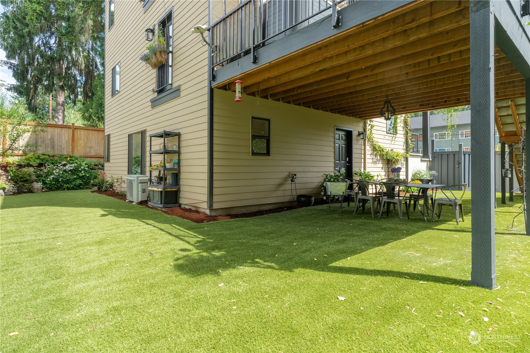 18613 103rd Avenue Northeast Bothell, WA 98011 - Photo 33 of 35 a view of a backyard with table and chairs and garden