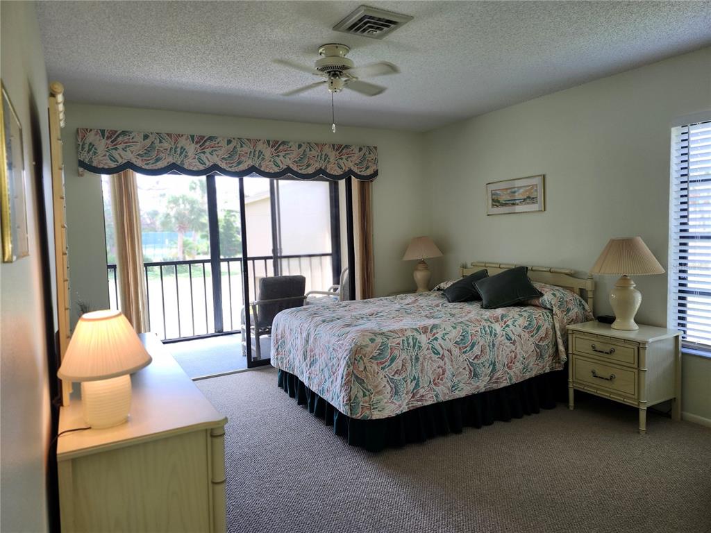 4260 Placida Road, Unit 21D Englewood, FL 34224 - Photo 18 of 38 a bedroom with a bed and a large window