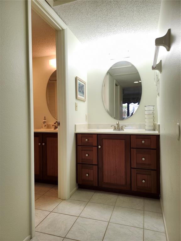 4260 Placida Road, Unit 21D Englewood, FL 34224 - Photo 21 of 38 a bathroom with a granite countertop sink and a mirror