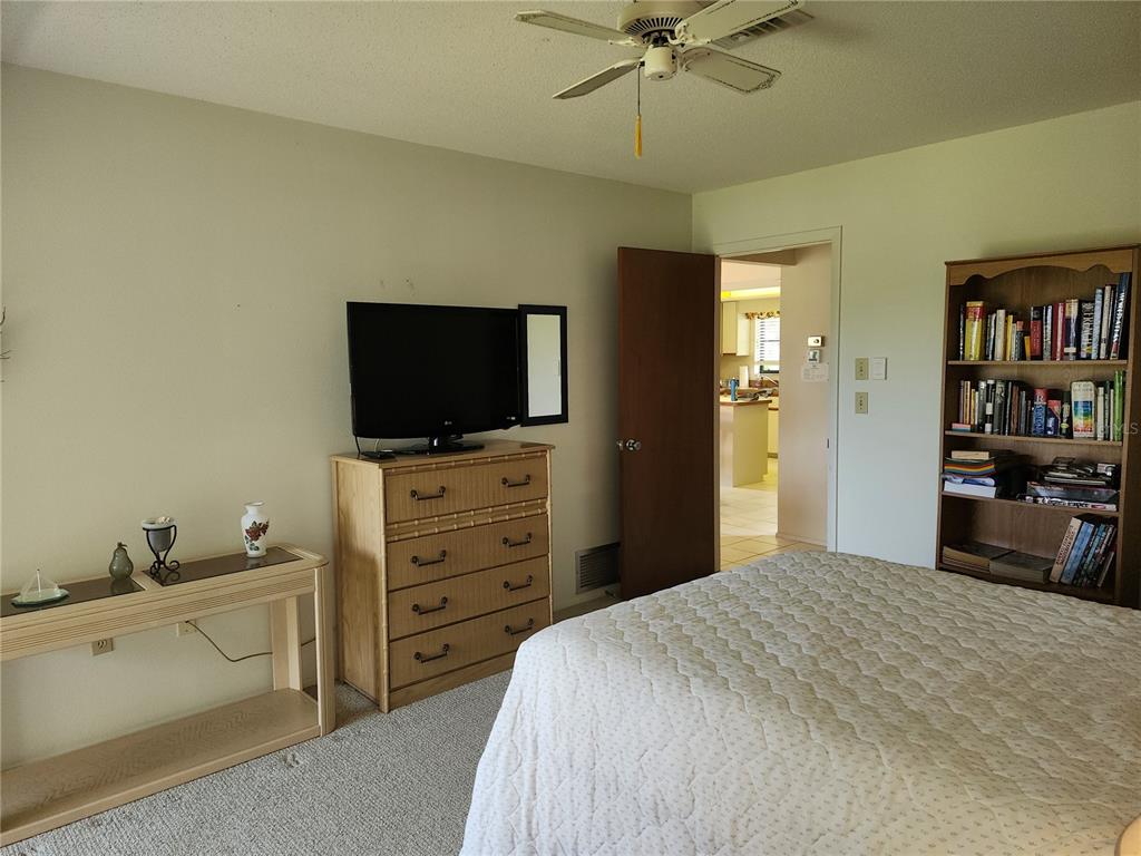 4260 Placida Road, Unit 21D Englewood, FL 34224 - Photo 25 of 38 a bedroom with a bed and a flat screen tv