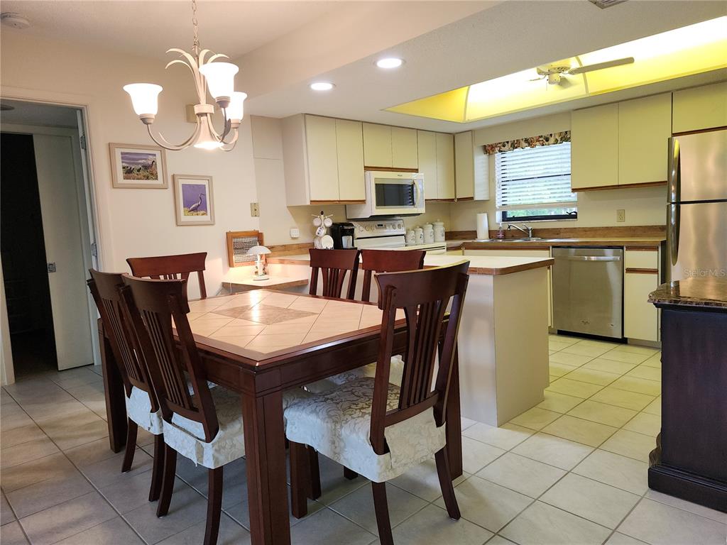 4260 Placida Road, Unit 21D Englewood, FL 34224 - Photo 6 of 38 a view of a dining room and kitchen with a table chairs