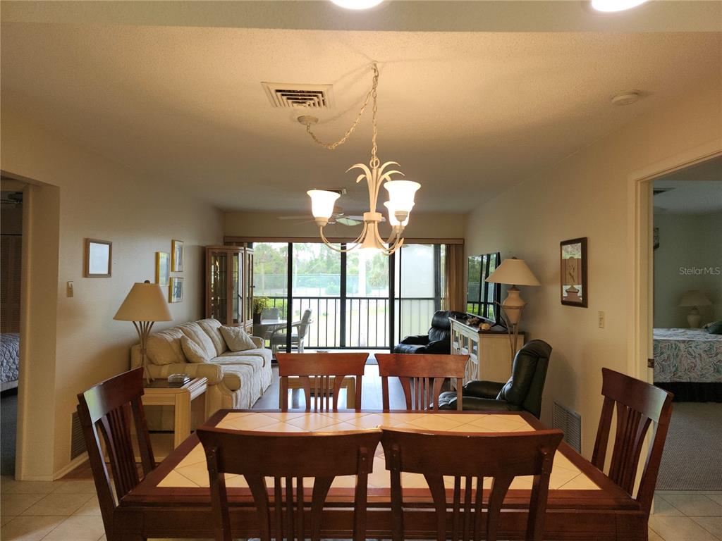 4260 Placida Road, Unit 21D Englewood, FL 34224 - Photo 10 of 38 a view of a dining room with furniture window and outside view