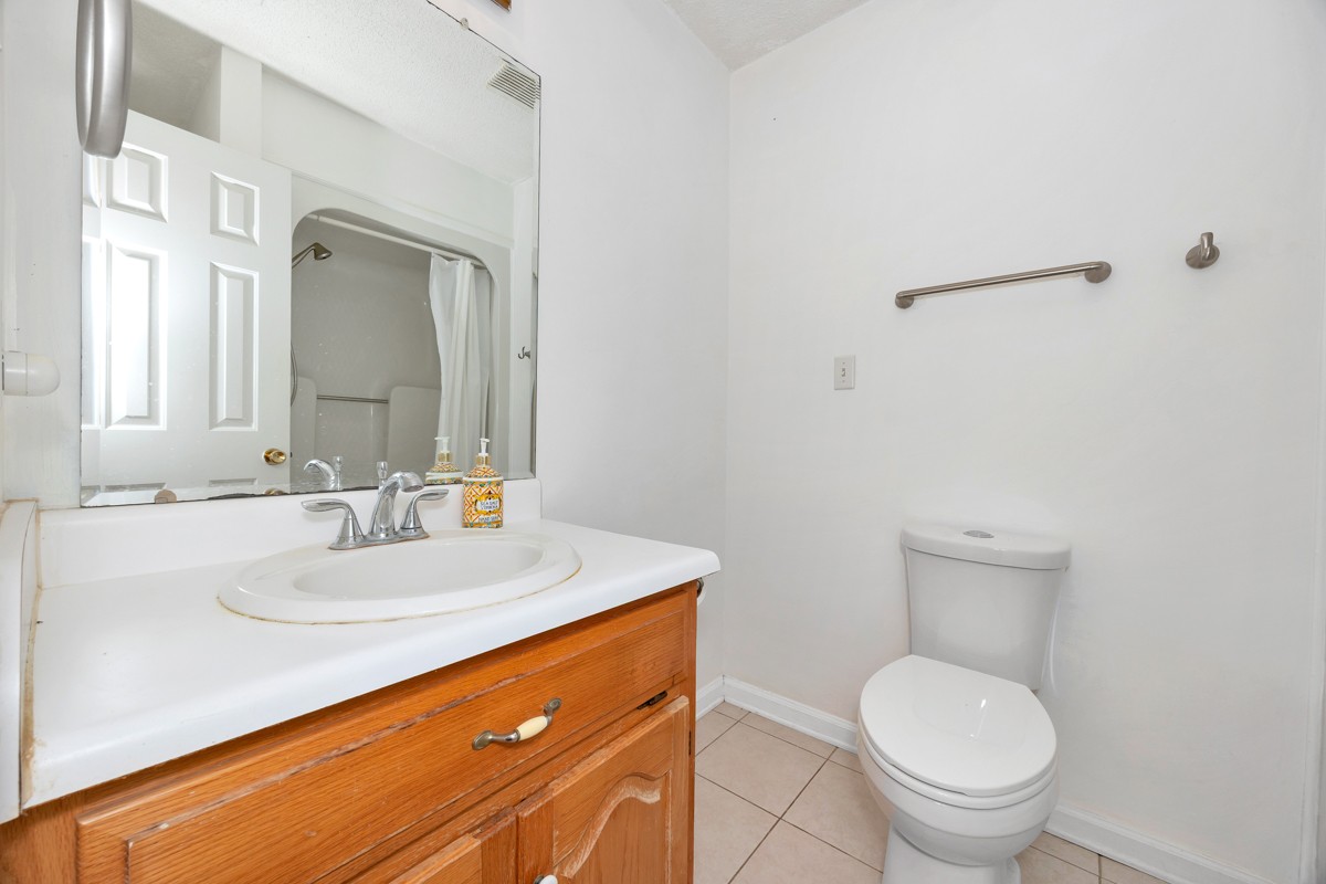 81 Slaughter Pen Road Ardmore, TN 38449 - Photo 13 of 63 a bathroom with a toilet a sink and mirror
