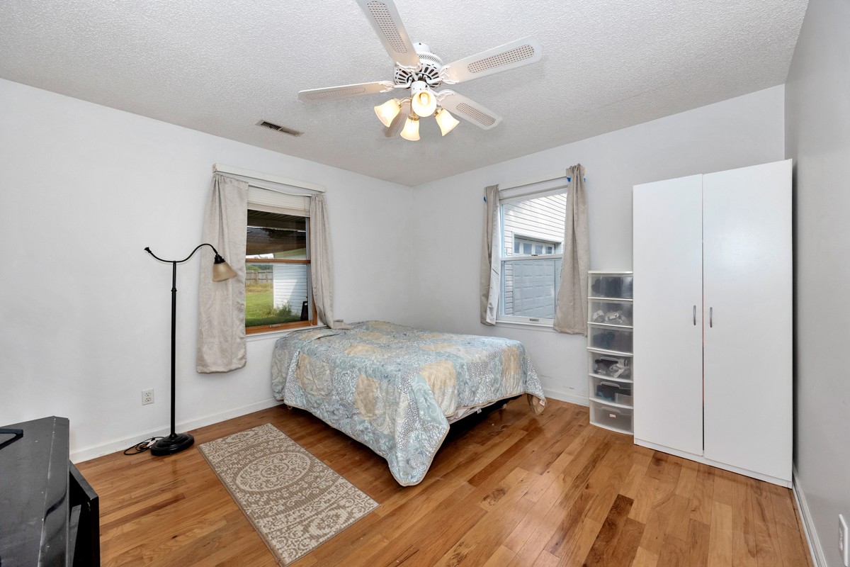 81 Slaughter Pen Road Ardmore, TN 38449 - Photo 15 of 63 a bedroom with a bed and wooden floor