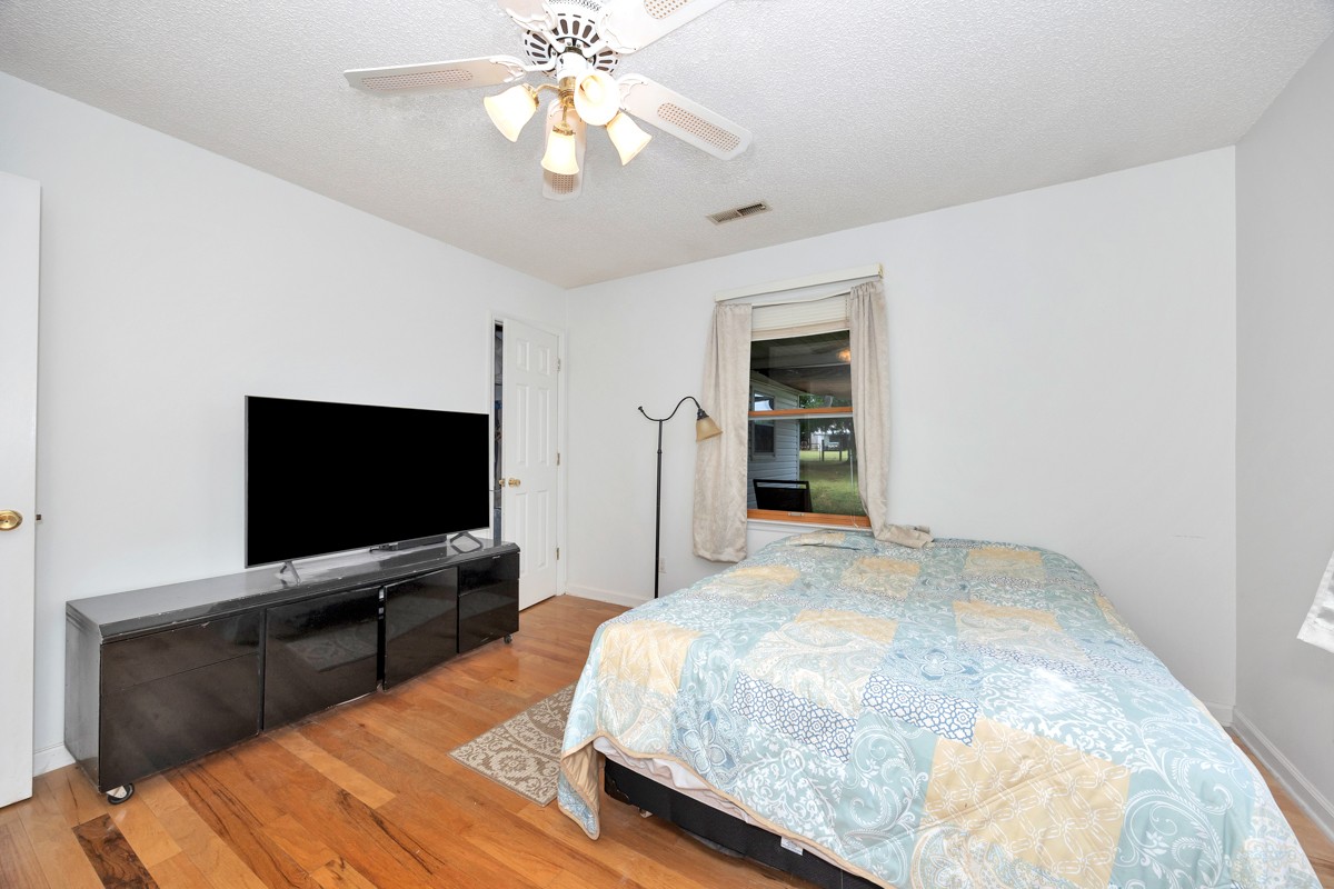 81 Slaughter Pen Road Ardmore, TN 38449 - Photo 16 of 63 a bedroom with a bed and a flat tv screen on wall