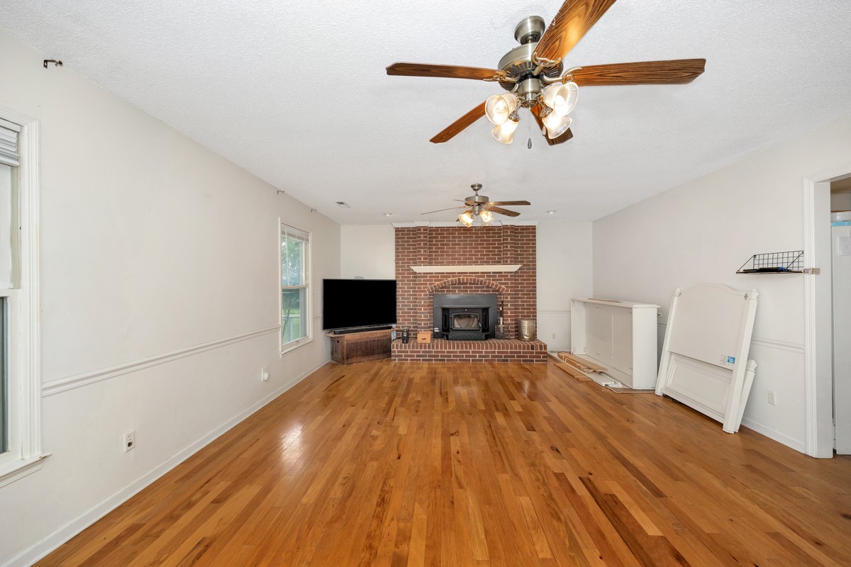 81 Slaughter Pen Road Ardmore, TN 38449 - Photo 4 of 63 a view of empty room with fireplace and wooden floor