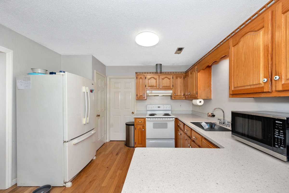 81 Slaughter Pen Road Ardmore, TN 38449 - Photo 5 of 63 a kitchen with stainless steel appliances granite countertop a refrigerator a stove top oven a sink and dishwasher