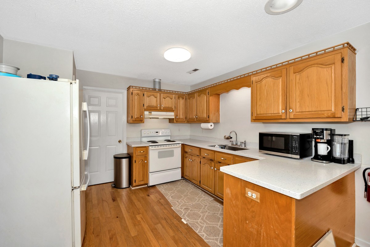 81 Slaughter Pen Road Ardmore, TN 38449 - Photo 6 of 63 a kitchen with stainless steel appliances granite countertop a stove refrigerator sink and dishwasher with wooden floor