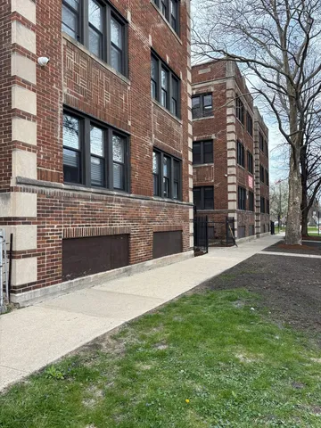 a view of a building with a yard