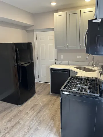 a kitchen with a sink and a refrigerator