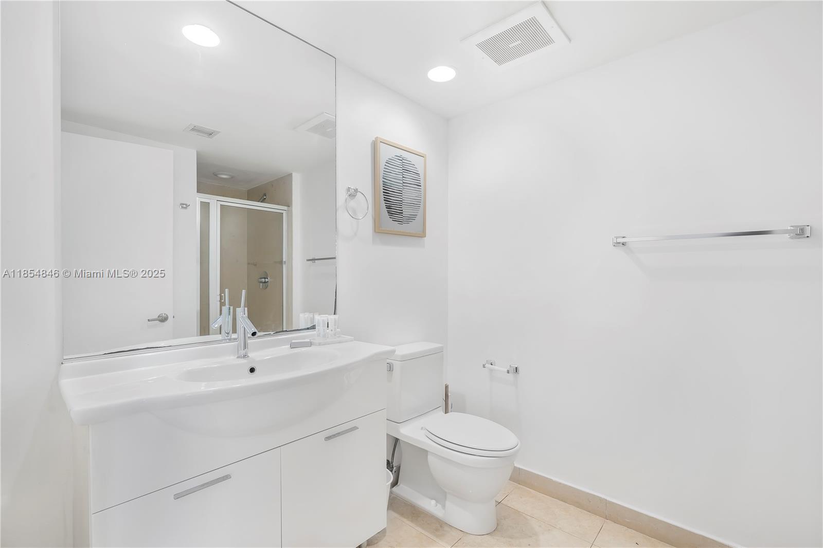 485 Brickell Avenue, Unit 4404 Miami, FL 33131 - Photo 11 of 14 a bathroom with a toilet sink and mirror