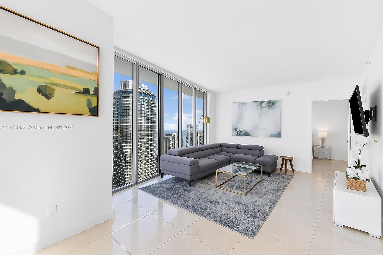 485 Brickell Avenue, Unit 4404 Miami, FL 33131 - Photo 3 of 14 a living room with furniture and a flat screen tv