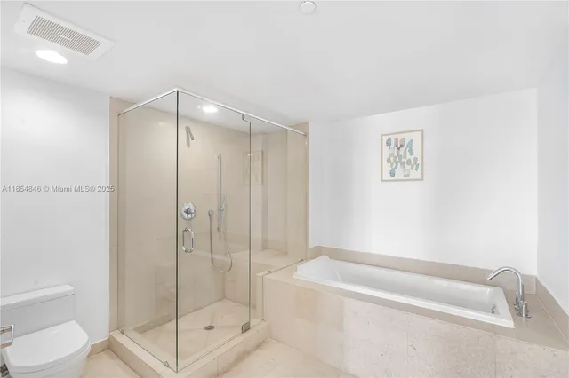 a bathroom with a shower and a toilet