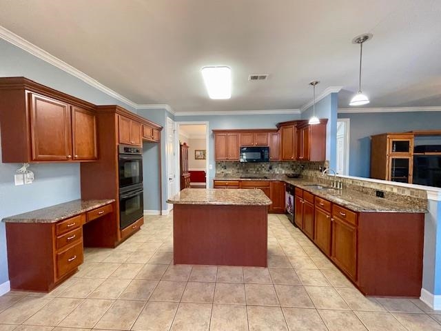 8028 Old Brownsville Road Bartlett, TN 38002 - Photo 10 of 35 a large kitchen with stainless steel appliances wooden cabinets a stove and a center island