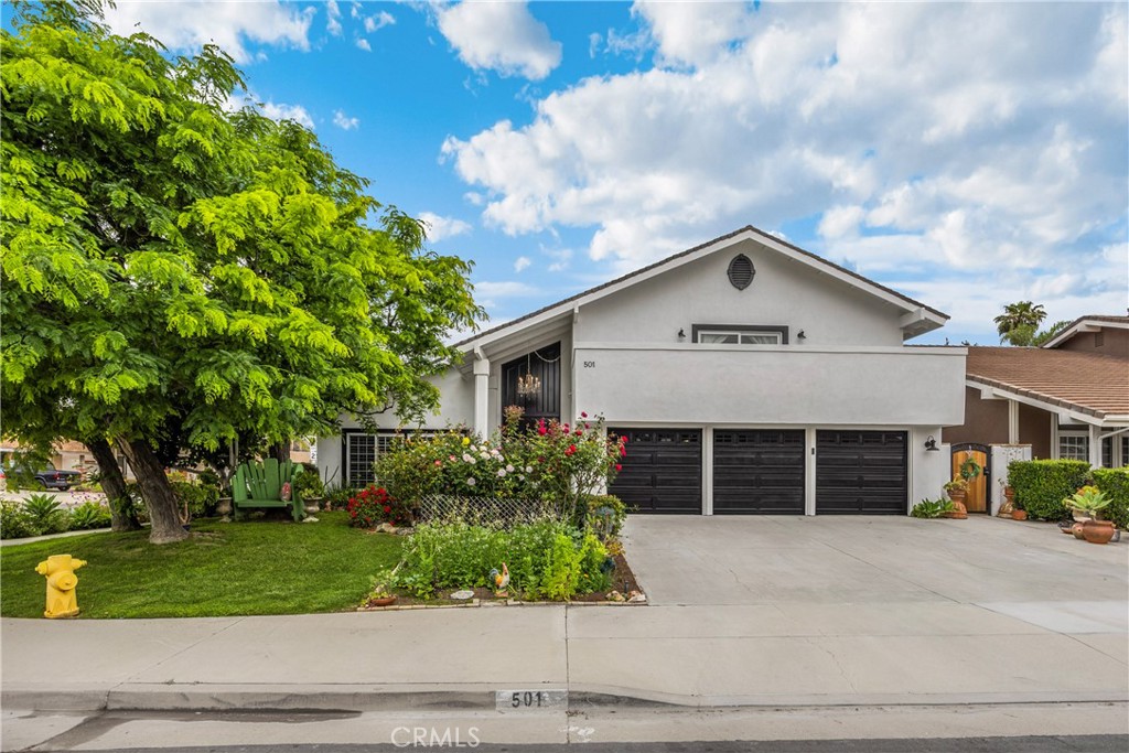 a front view of a house with a garden