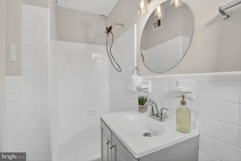 a bathroom with a sink vanity and a mirror