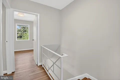 a view of hallway with wooden floor