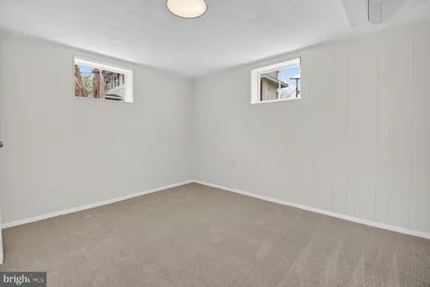 a view of an empty room with a painting on the wall