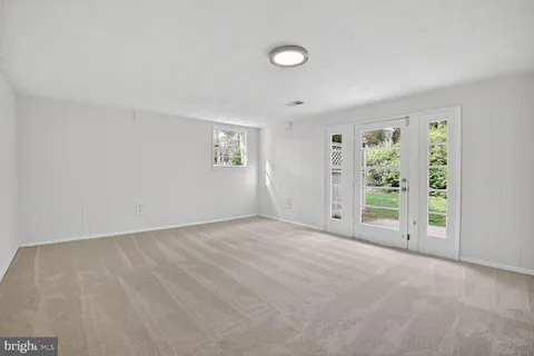 an empty room with windows and closet