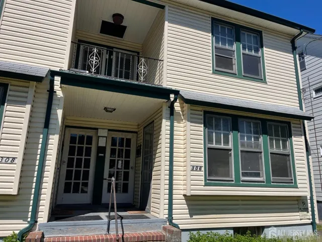 a view of brick house with large windows