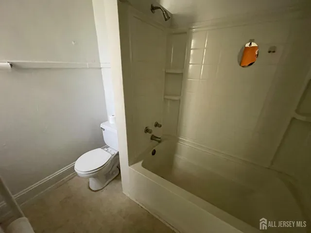 a bathroom with a shower and a toilet